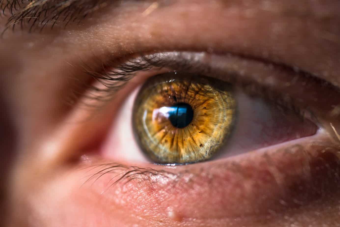 An eye looks forward with a slight reflection in it, at an EMDR appointment