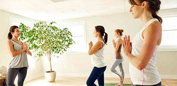 Women recovering from drug and alcohol addiction taking a yoga class at Mountainside rehab center