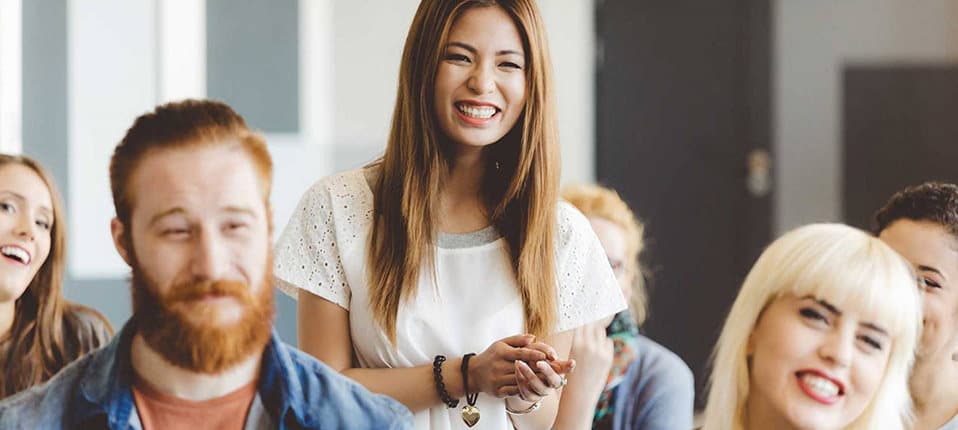 Woman smiling with group of rehab patients engaging in holistic therapy