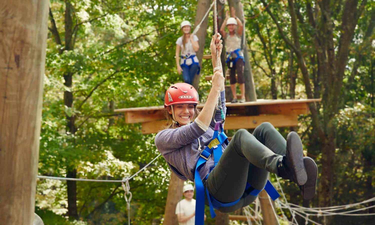 woman on rope course at mountainside