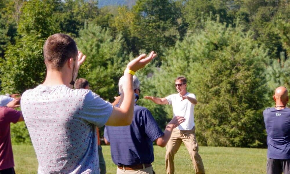 Mountainside treatment center patients performing Qi Gong and tai chi for holistic healing.