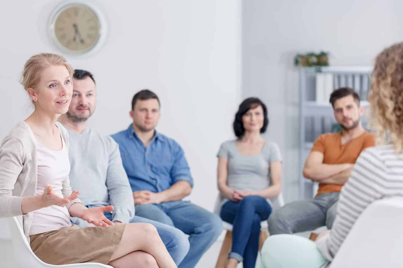 Group Therapy session with woman is talking to group