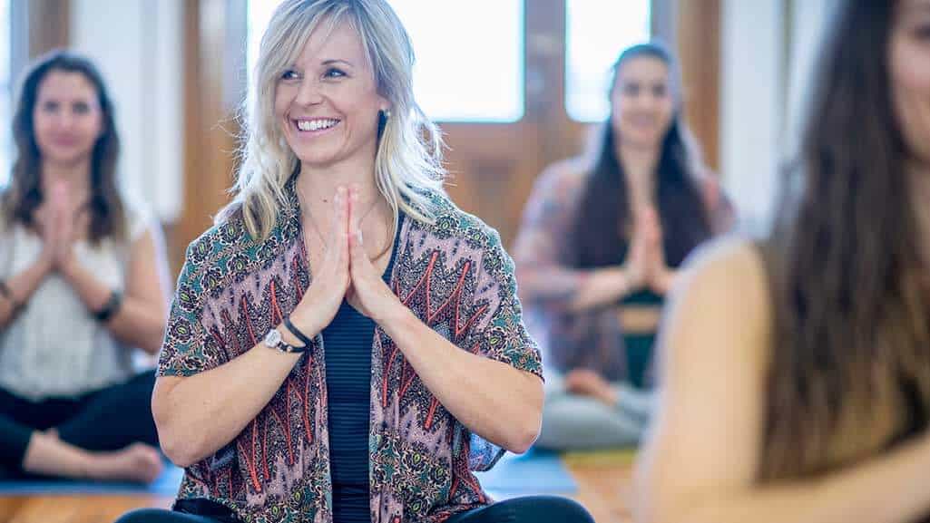 Woman in prayer pose in yoga session
