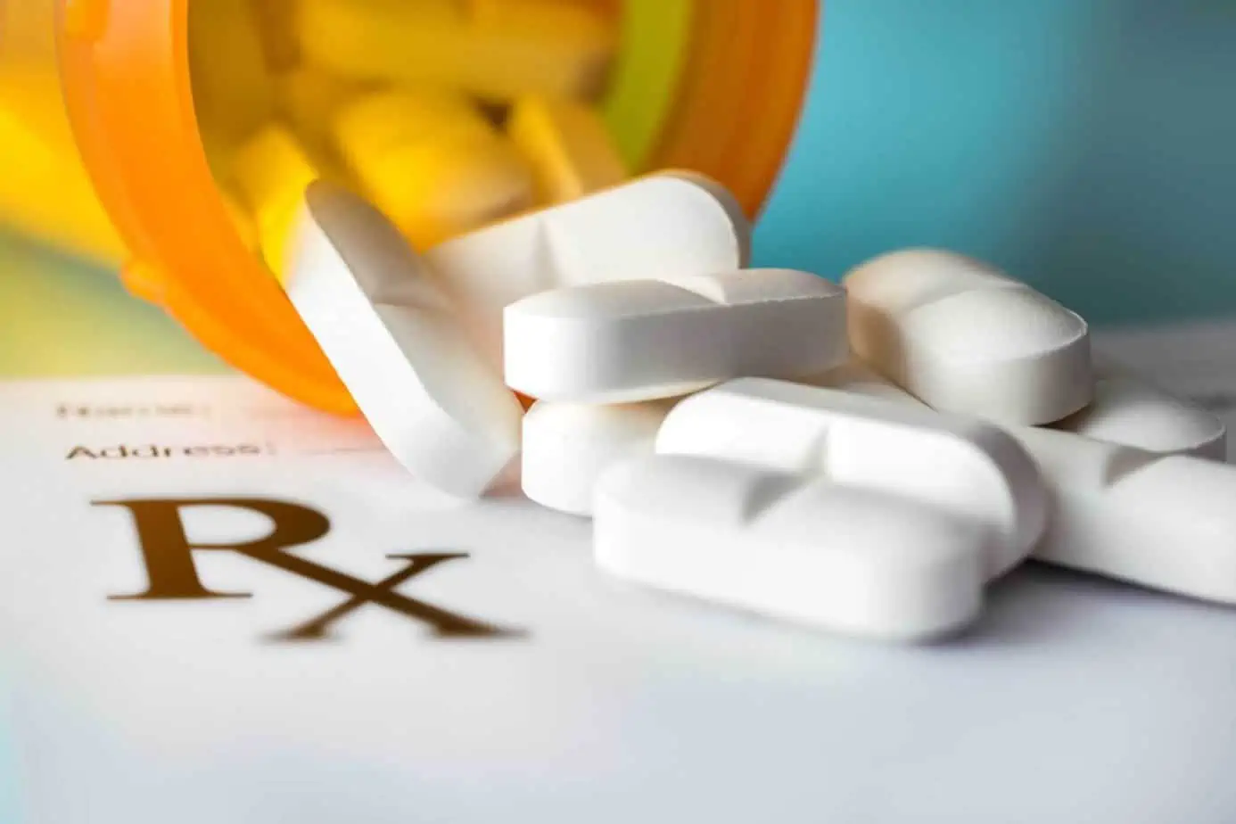 Close-up image of a prescription medication bottle with spilled pills