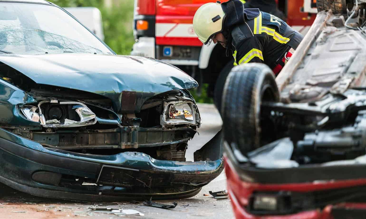 fireman standing at car accident crash
