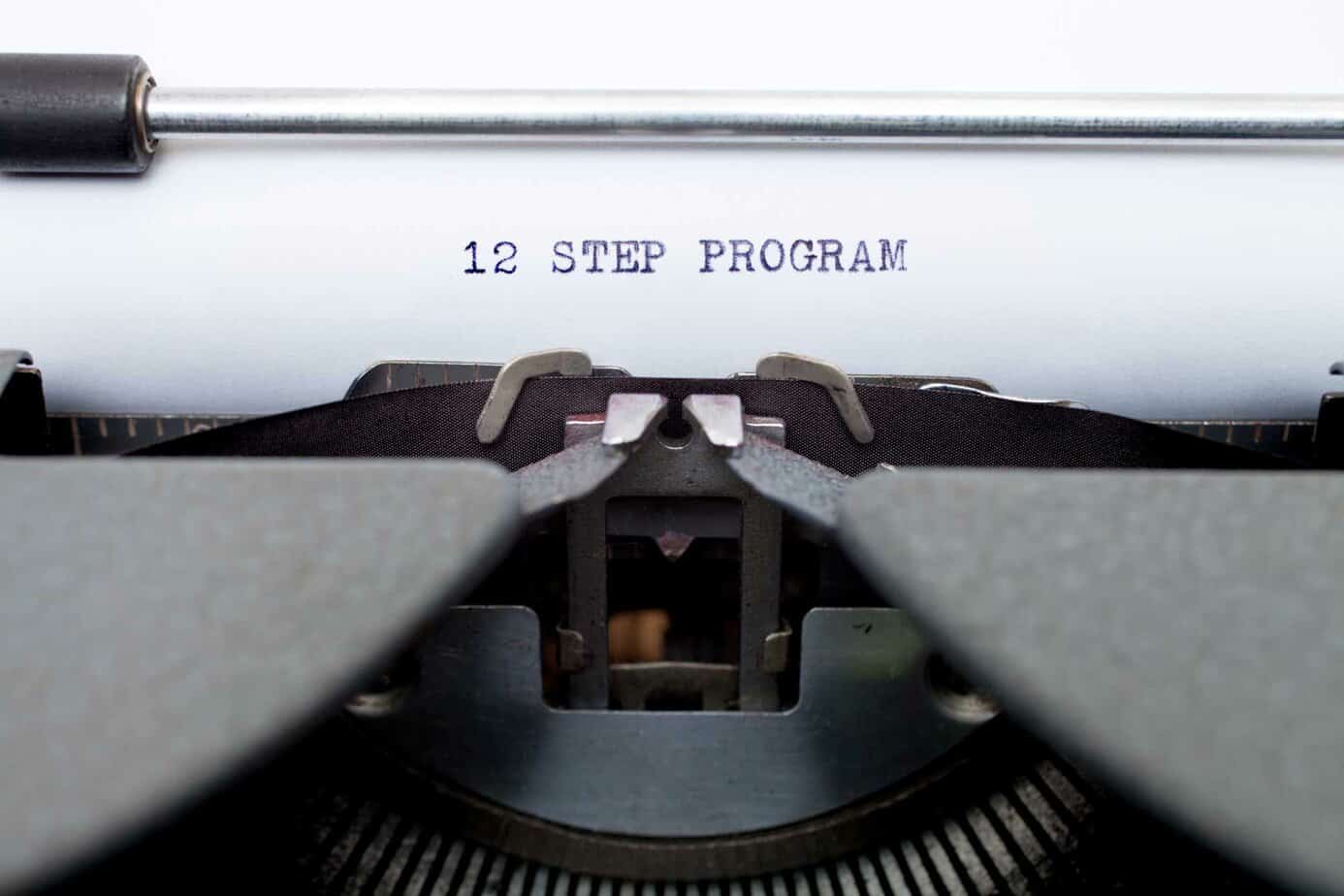 typewriter with 12 step program typed out