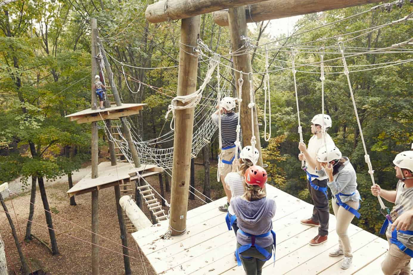 group of people doing a high ropes activity course at Mountainside Treatment Center in Canaan