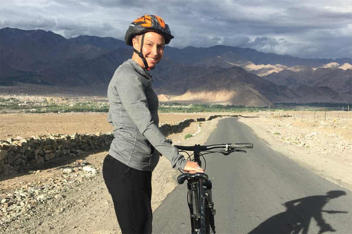 Jessica Dolan riding a bicycle by mountains