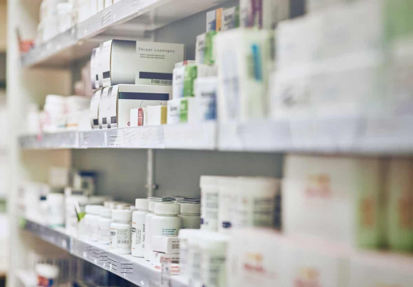 prescription medications on pharmacy shelves