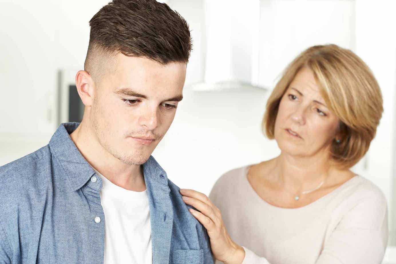 concerned mother talking to son about alcohol use