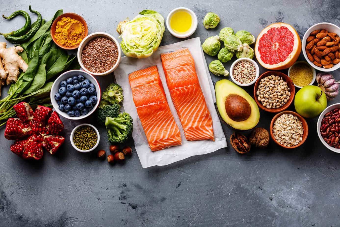 salmon, avocado and various foods displayed on the coutner
