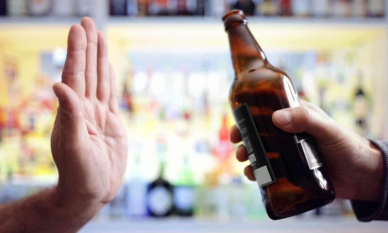 hand refusing beer in dry january