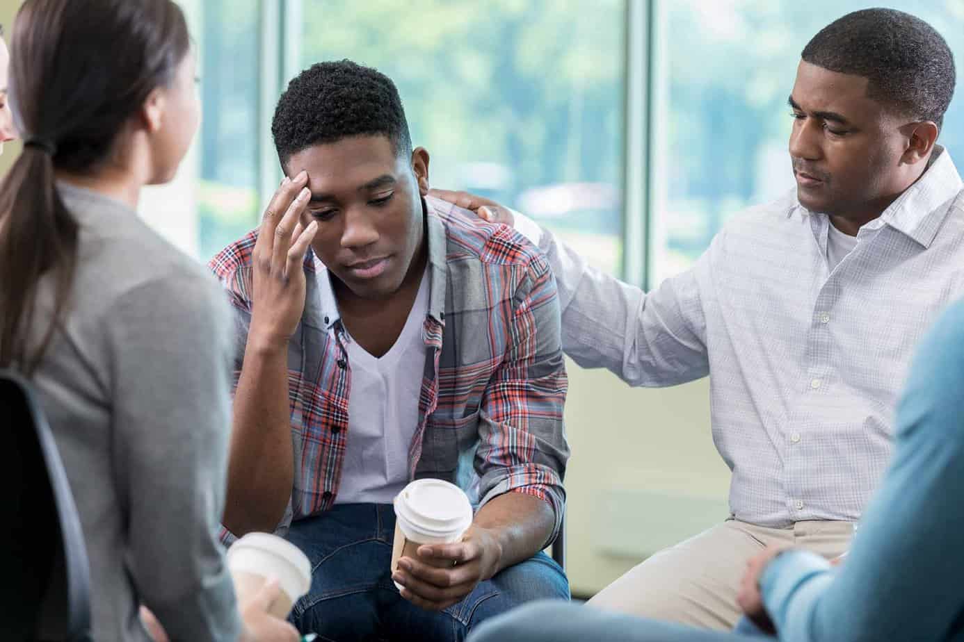 young male sponsor relapses feeling ashamed surrounded by support system