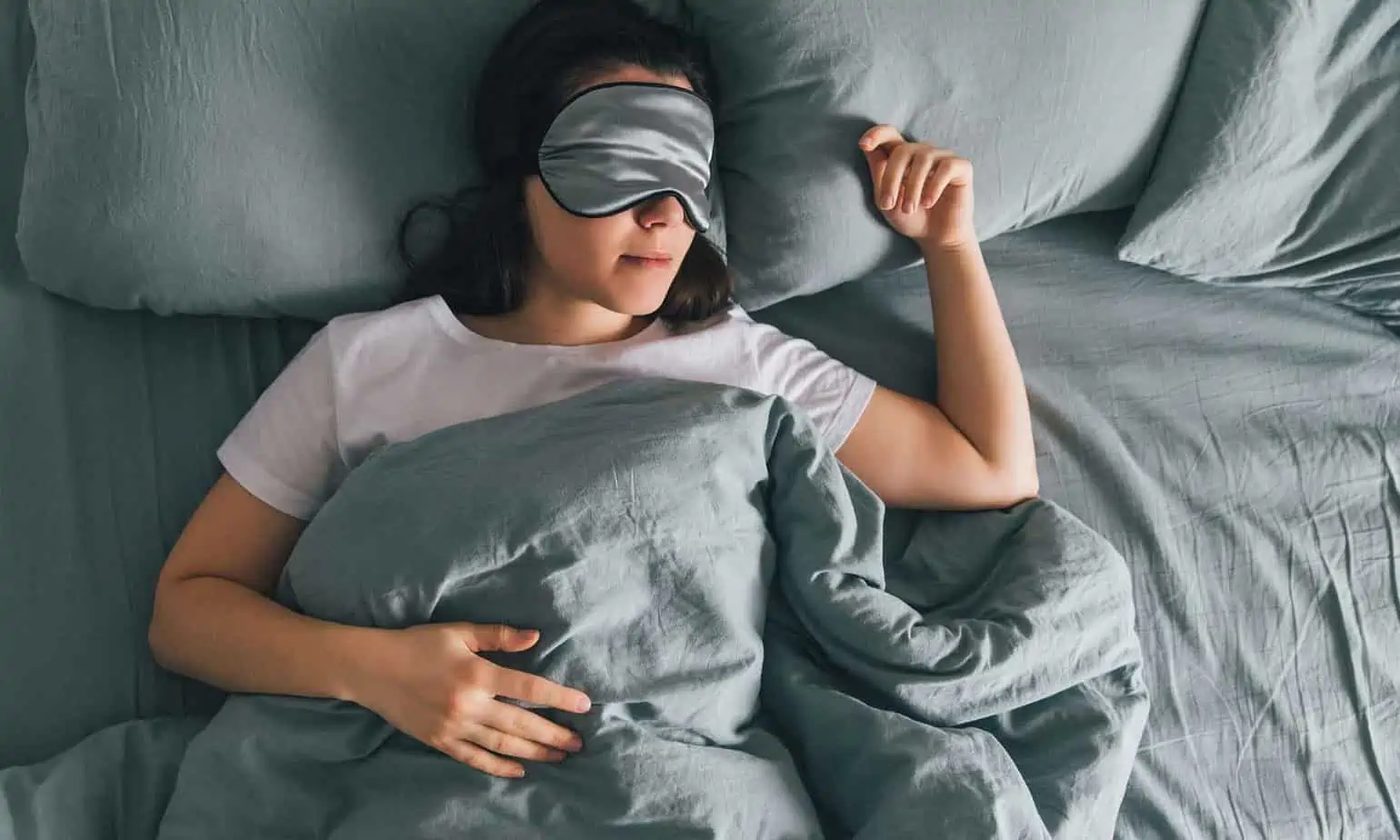 woman sleeping in bed with eye mask on