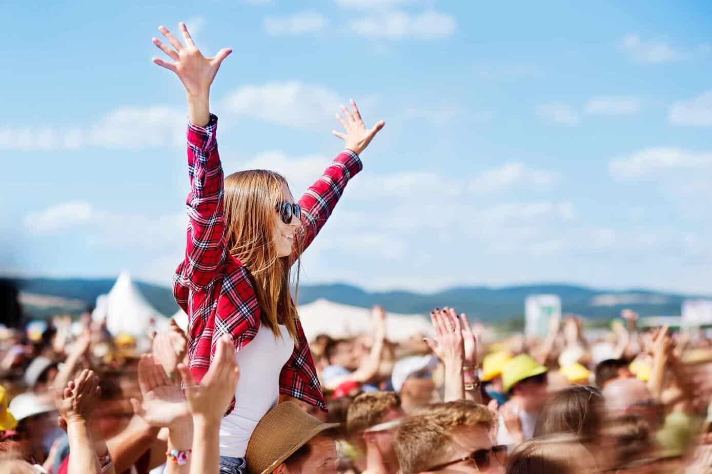 woman celebrating in crowd at music festival