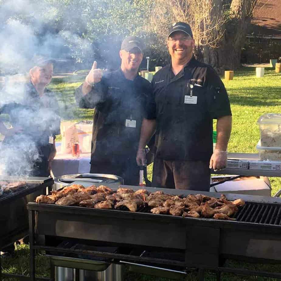 2 men over barbecue grill at Mountainside Treatment Center Canaan Alumni Retreat Event 2018