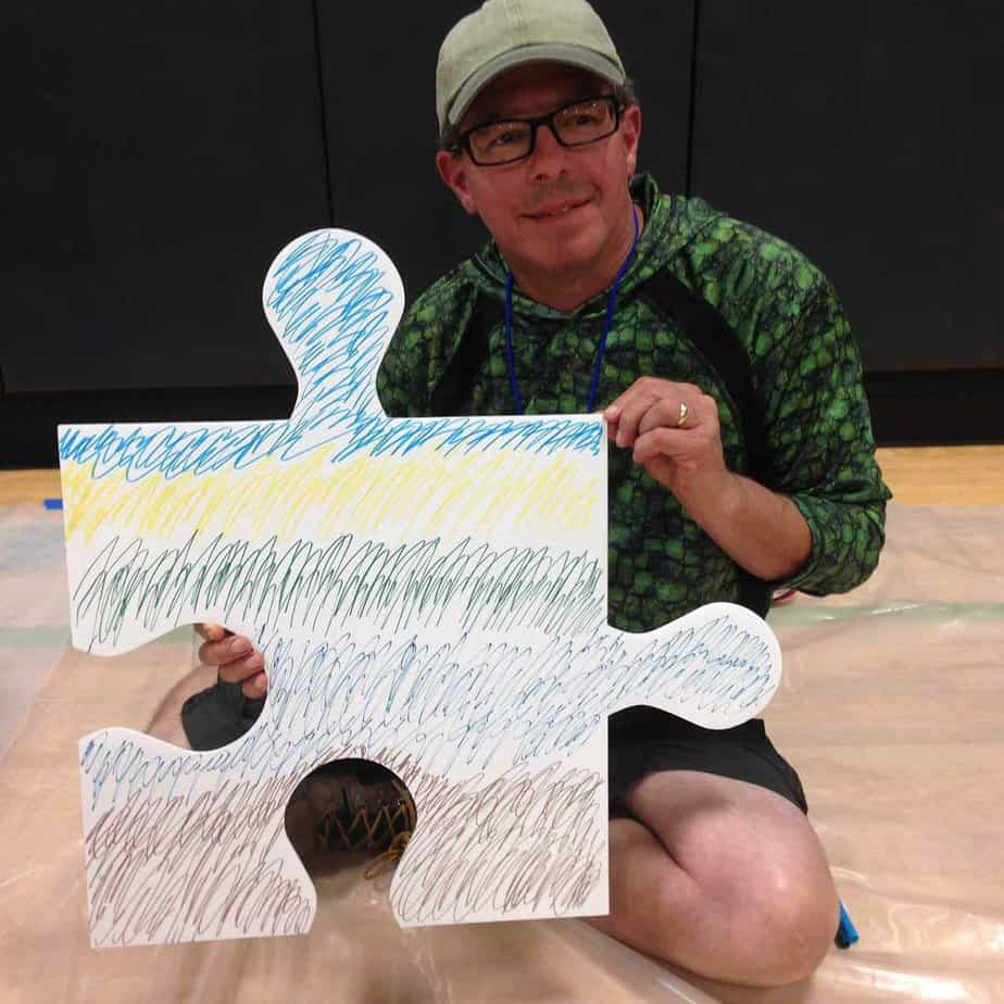 Man with jigsaw puzzle piece at Mountainside Treatment Center Alumni Retreat 2017 in Canaan