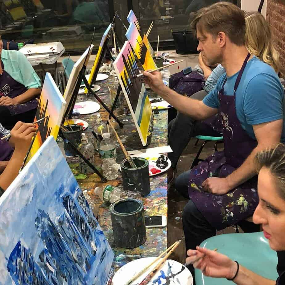 Man and woman painting at Mountainside Treatment Center Alumni Paint Night Event in NYC