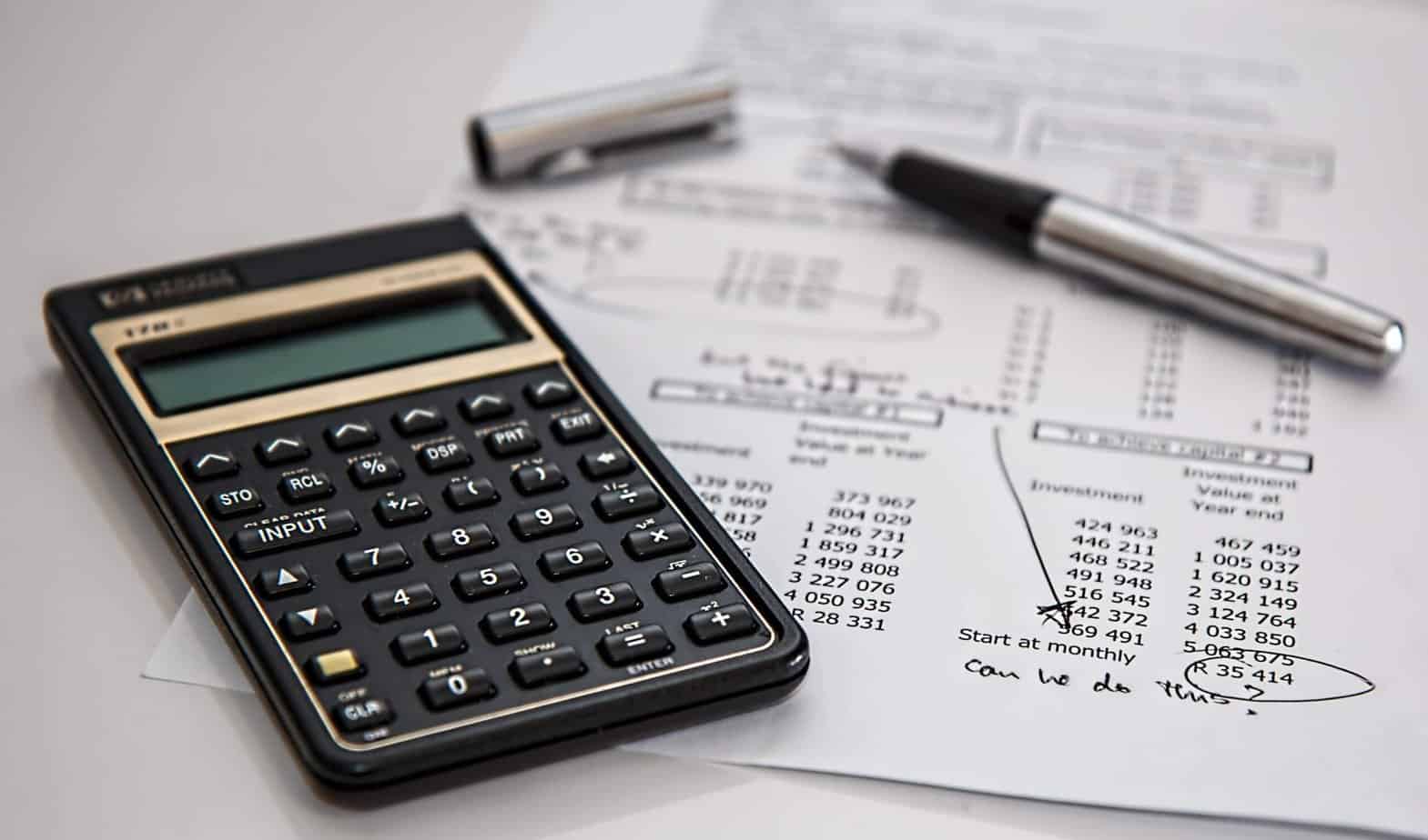Desk with calculator with budget planning paper- Pexels stock image