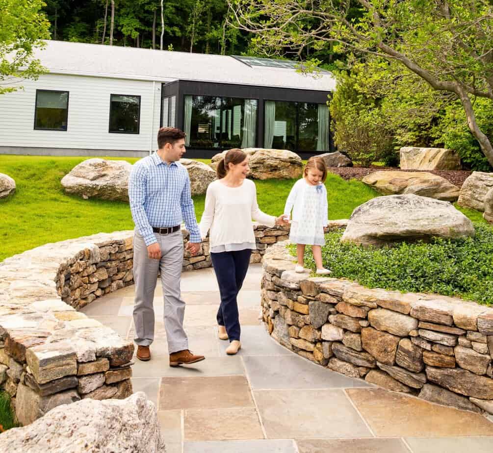 Family strolling in Mountainside's Addiction Treatment Center's Courtyard