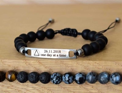 recovery bracelet with black beads and sobriety date engraved on metal