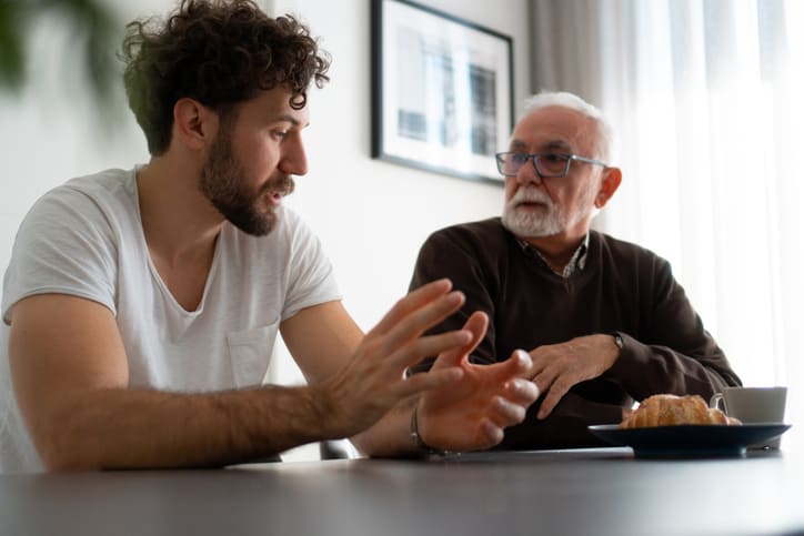 Worried man discussing boundaries in recovery with his son
