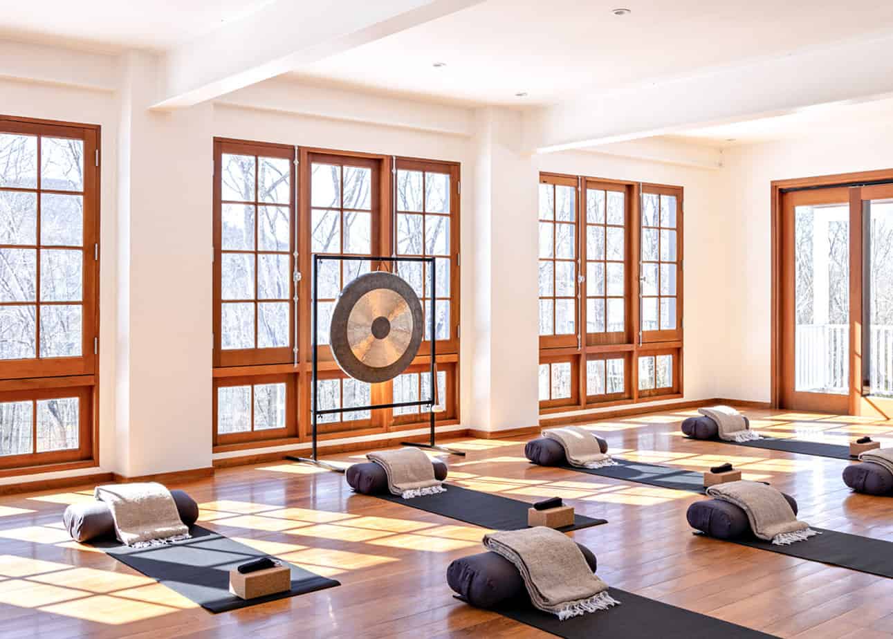 Yoga mats laid out in light-filled yoga studio at sober living house in Connecticut