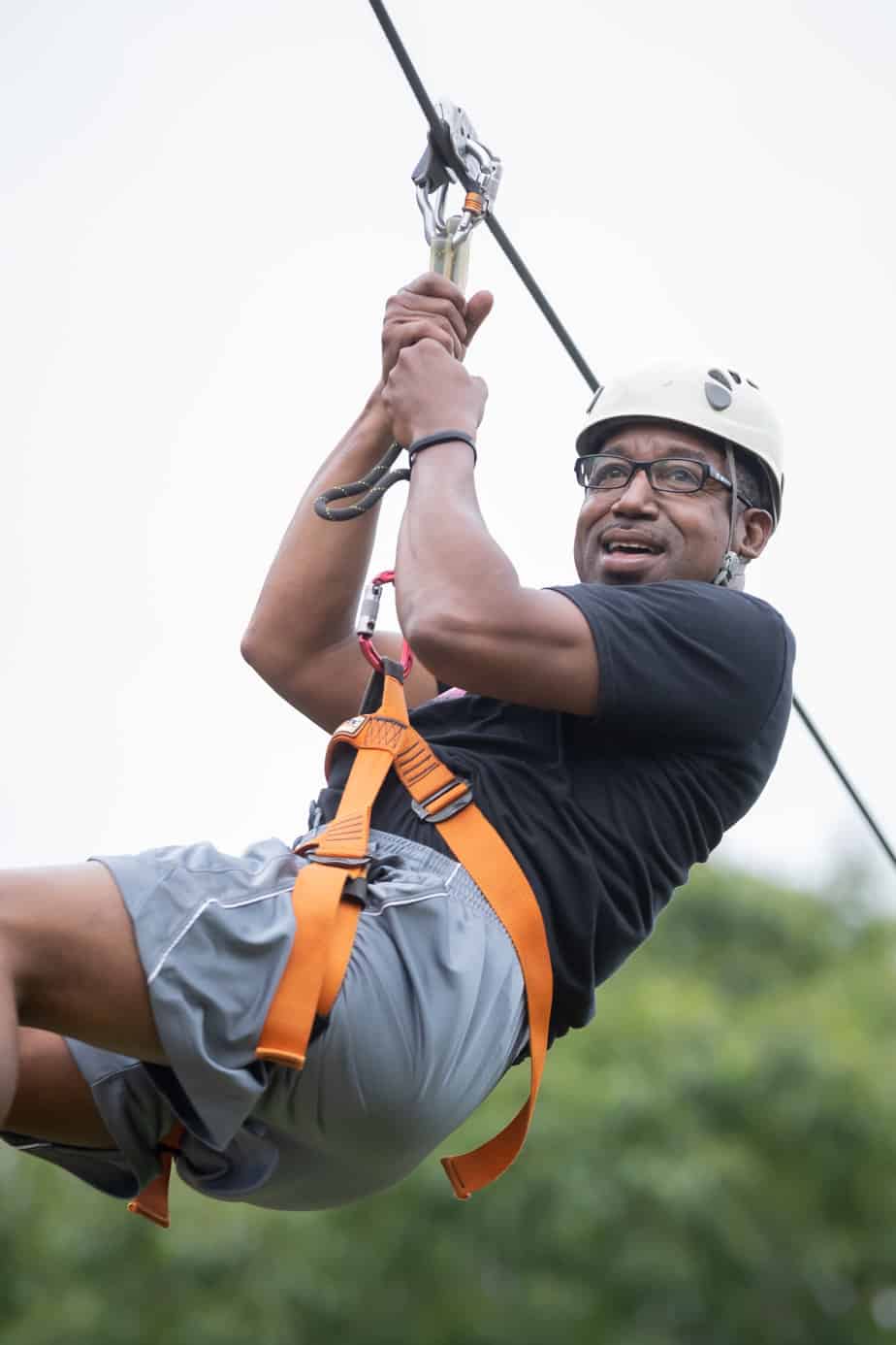An African-American man on a zipline at Mountainside treatment center in CT.