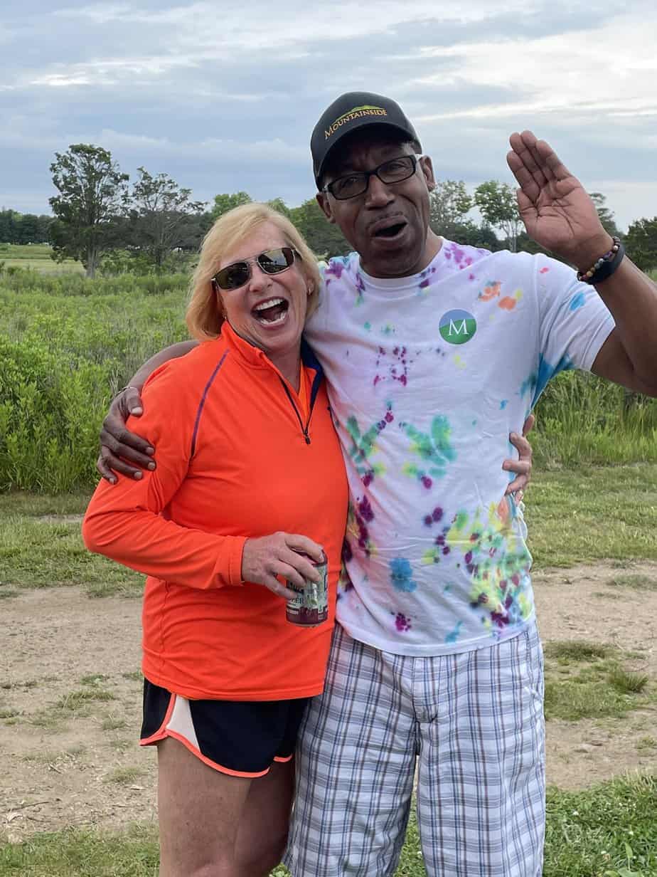 Man and woman smiling outside at Mountainside Treatment Center Alumni Sober Beach BBQ 2022