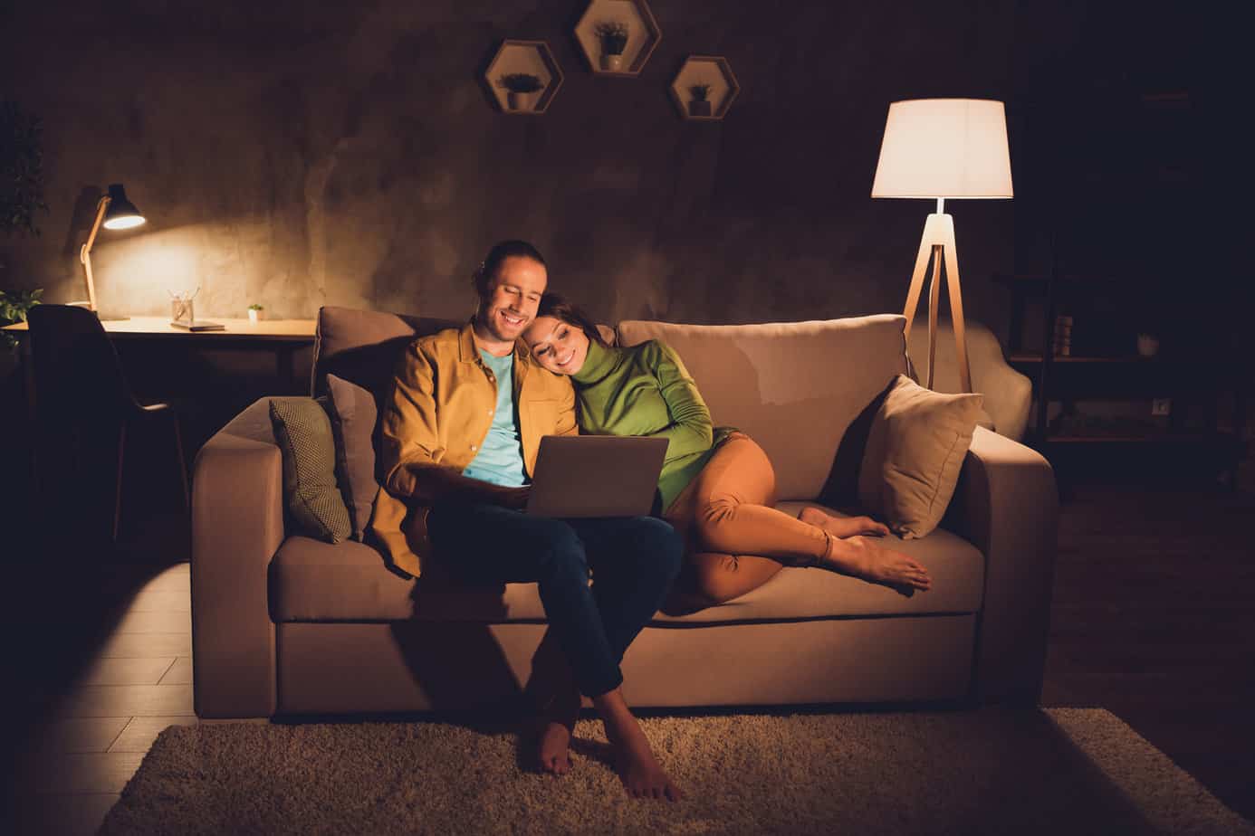 couple relaxing on couch with lamp