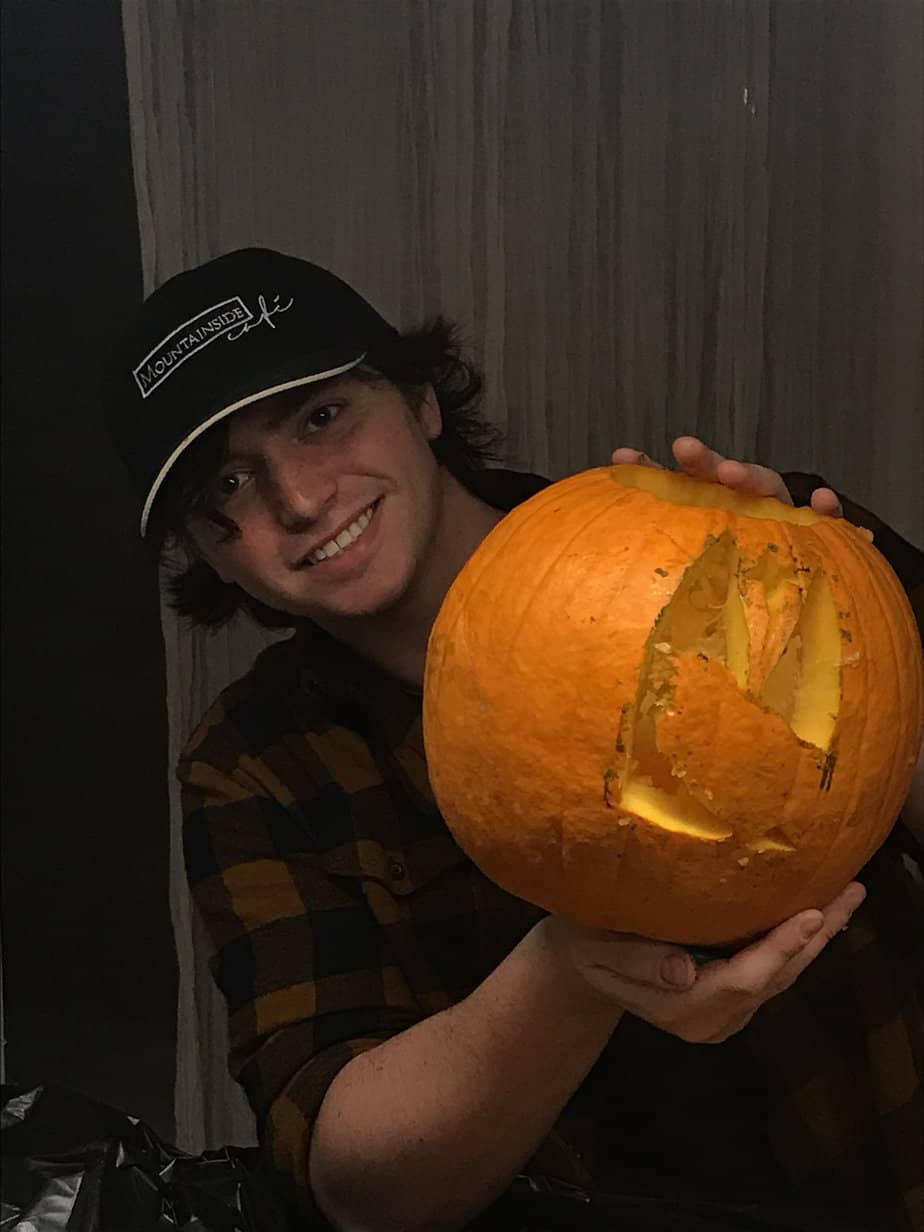 Man smiling holding pumpkin at Mountainside Treatment Center Extended Care Jack-O-Lantern Carving Event October 2021