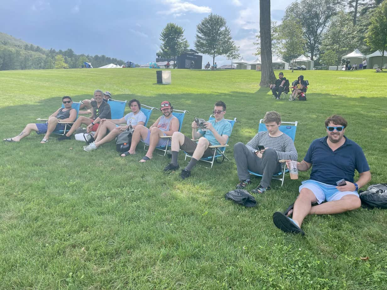 Group photo of men smiling outside on lawn chairs at Mountainside Treatment Center Extended Care Lime Rock Park Event Summer 2022