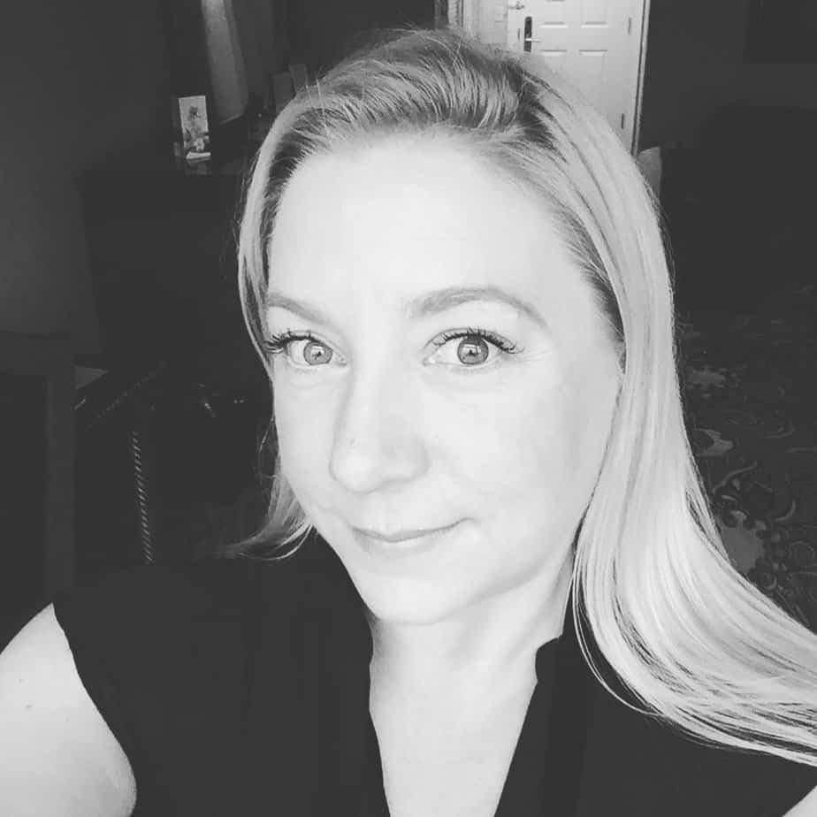 smiling woman poses for selfie in living room black and white