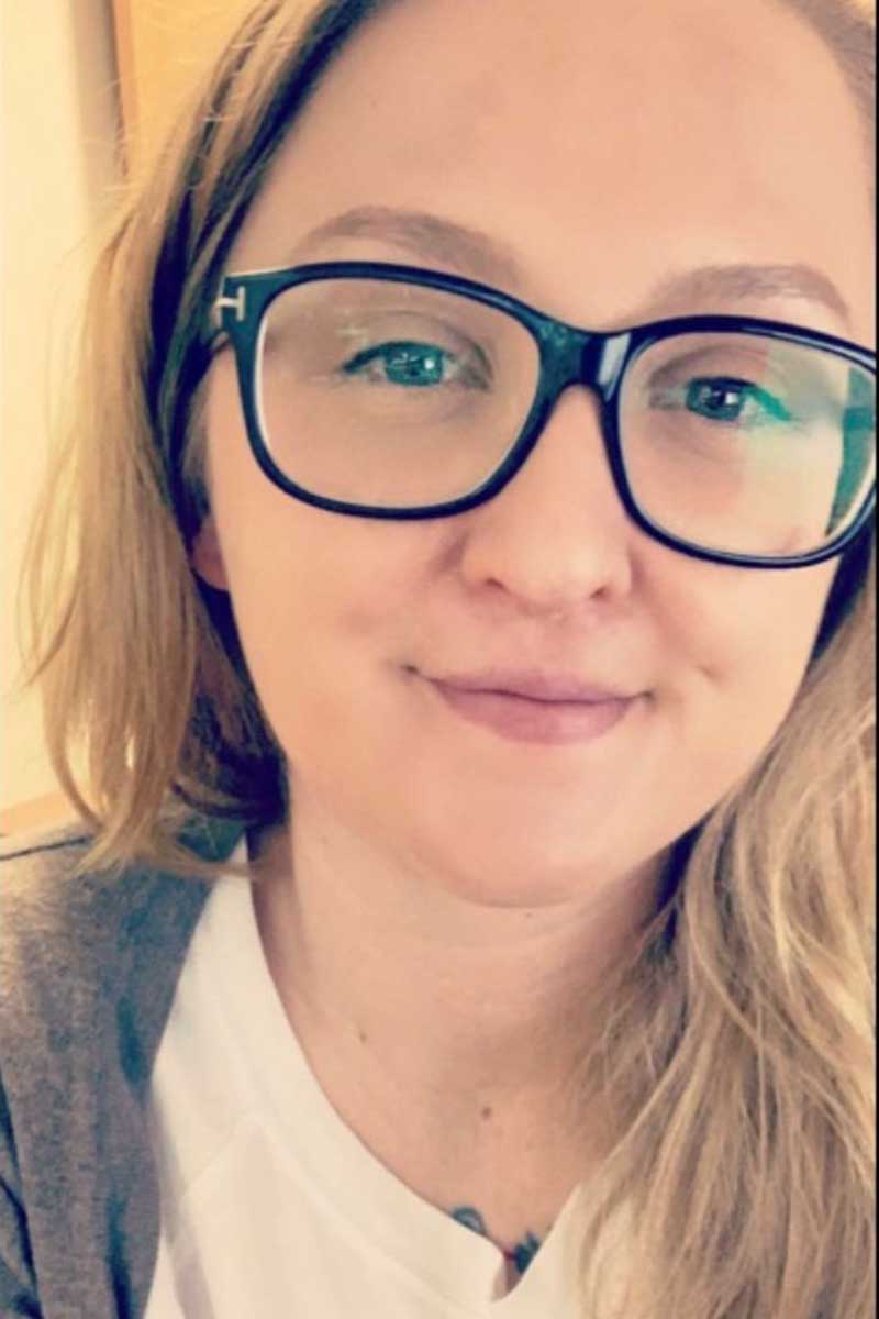 smiling woman in glasses selfie