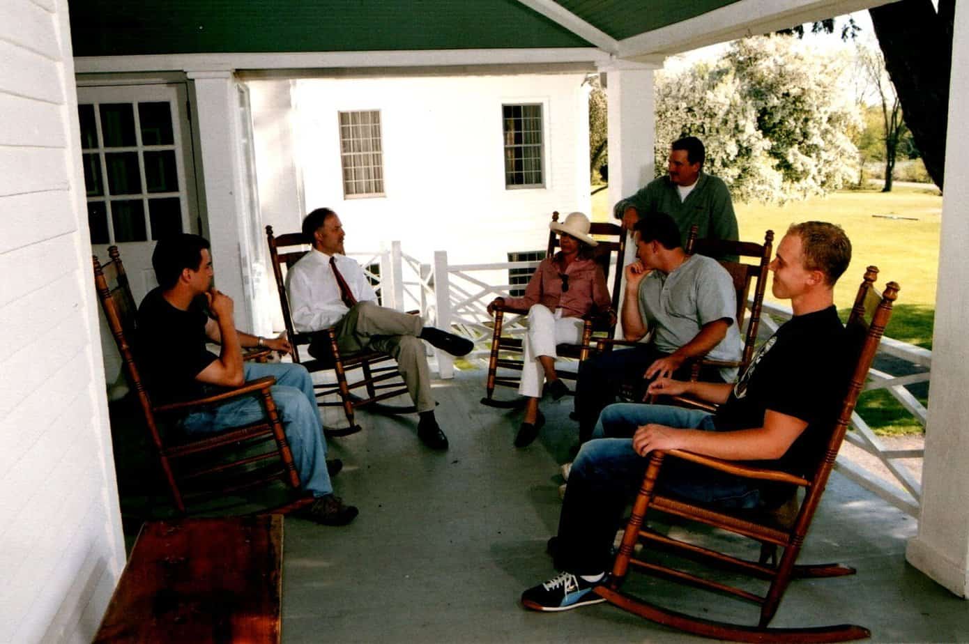 A group meeting on a porch.