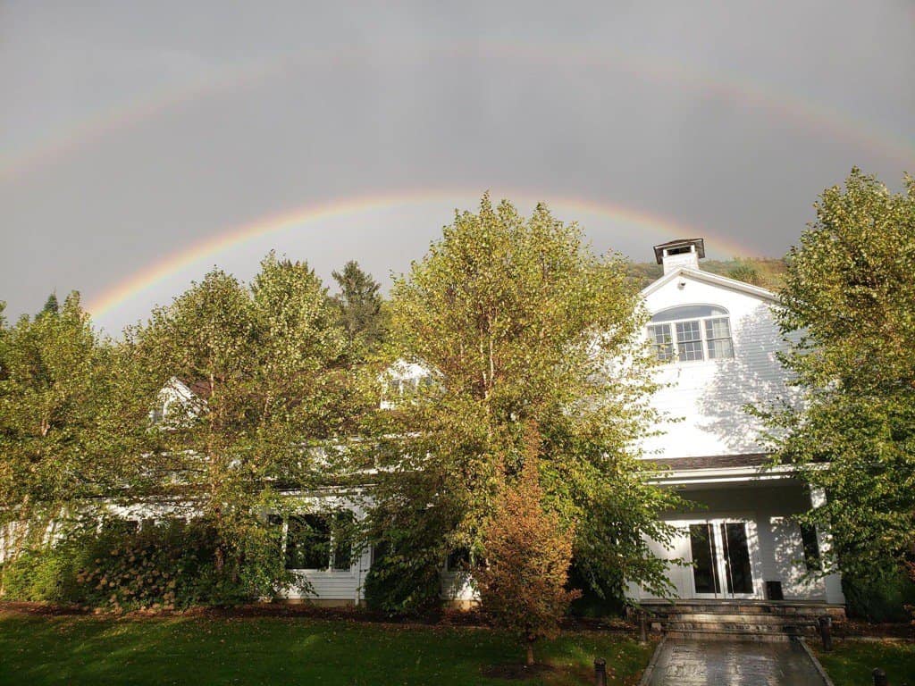 canaan campus with rainbow over main building