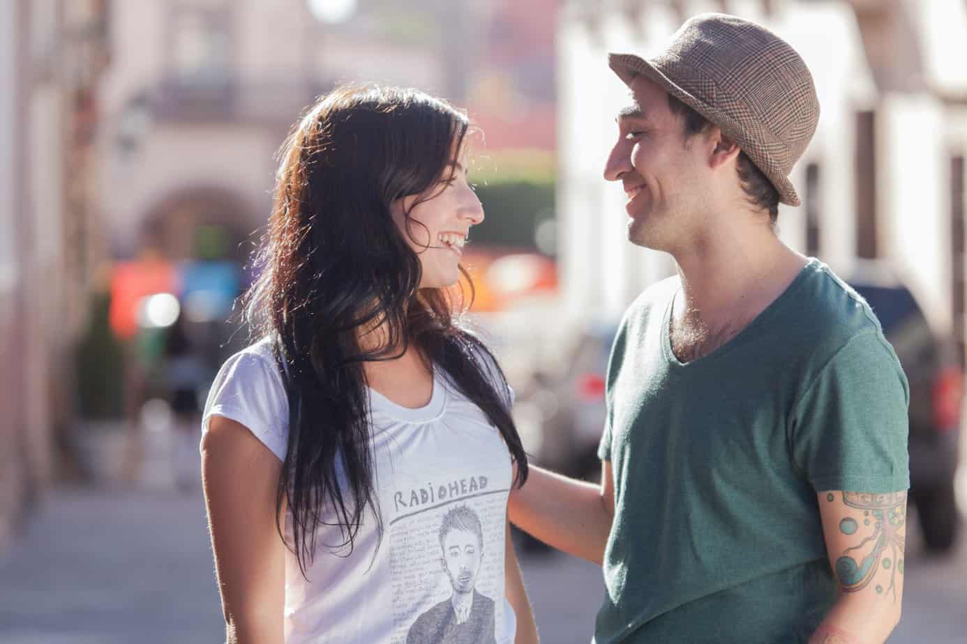 young couple walking down the street and flirting with each other