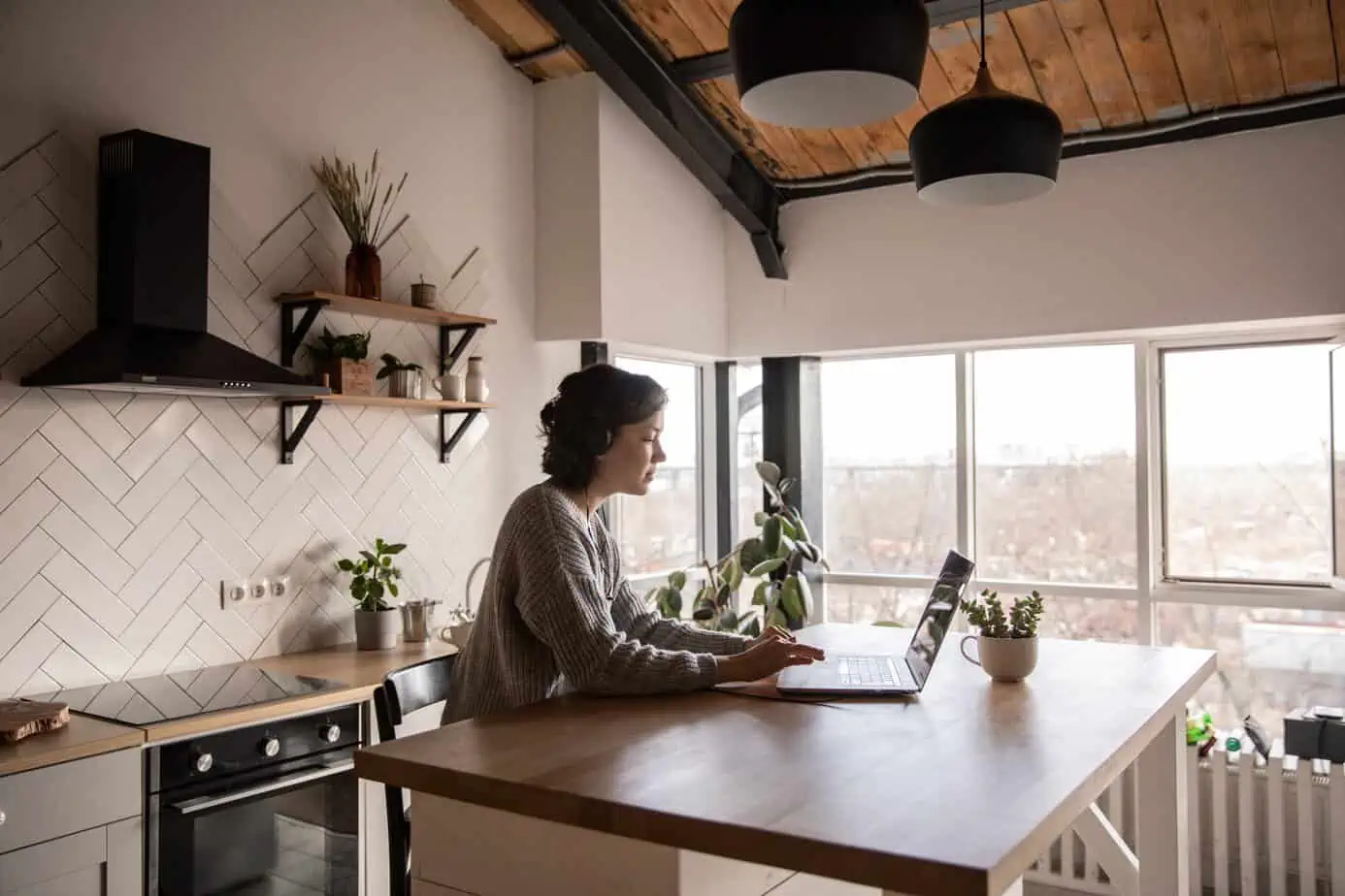 Happy woman using computer for virtual addiction treatment in her home.