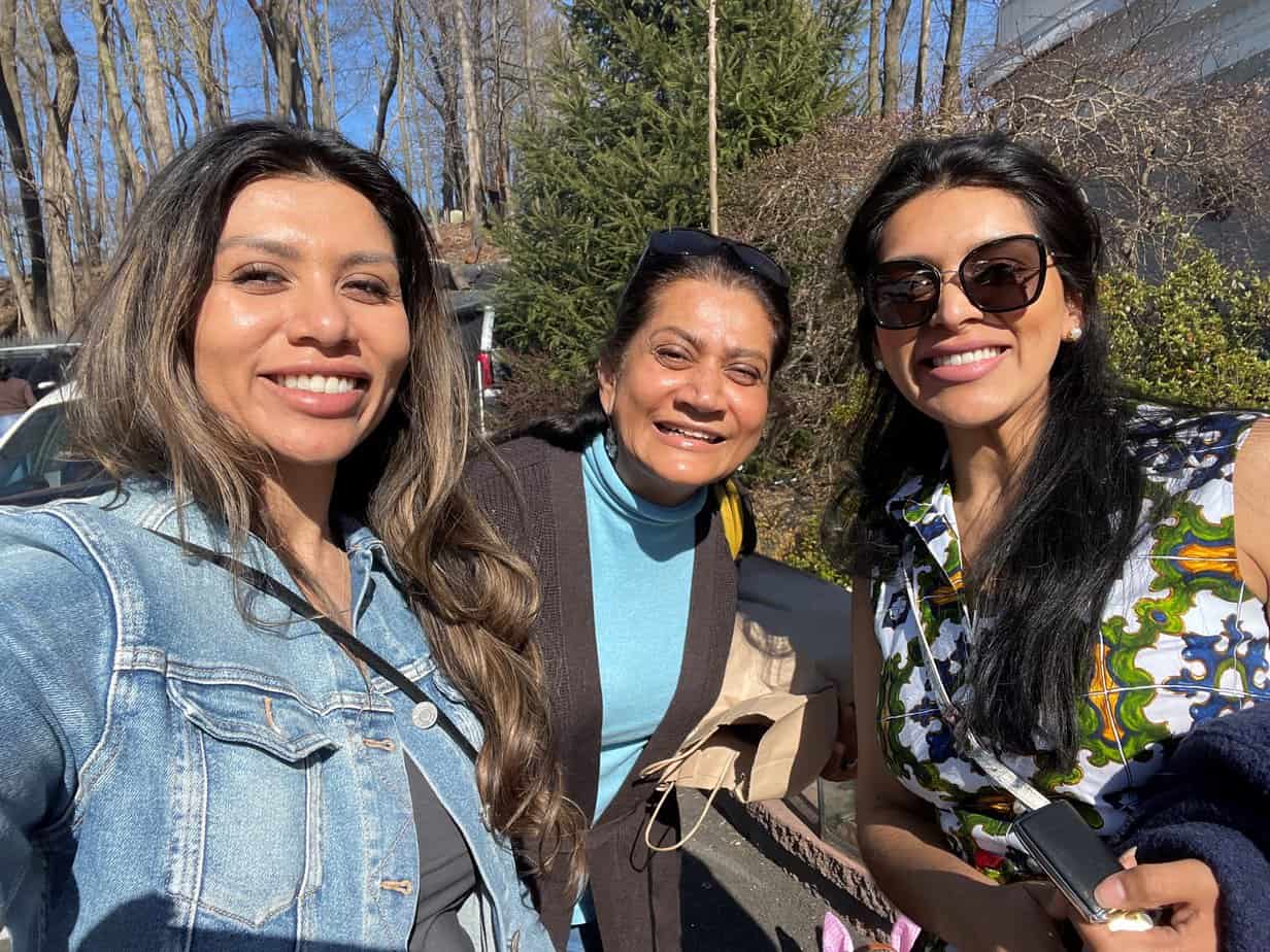 mother and two daughters taking a selfie outside in nature