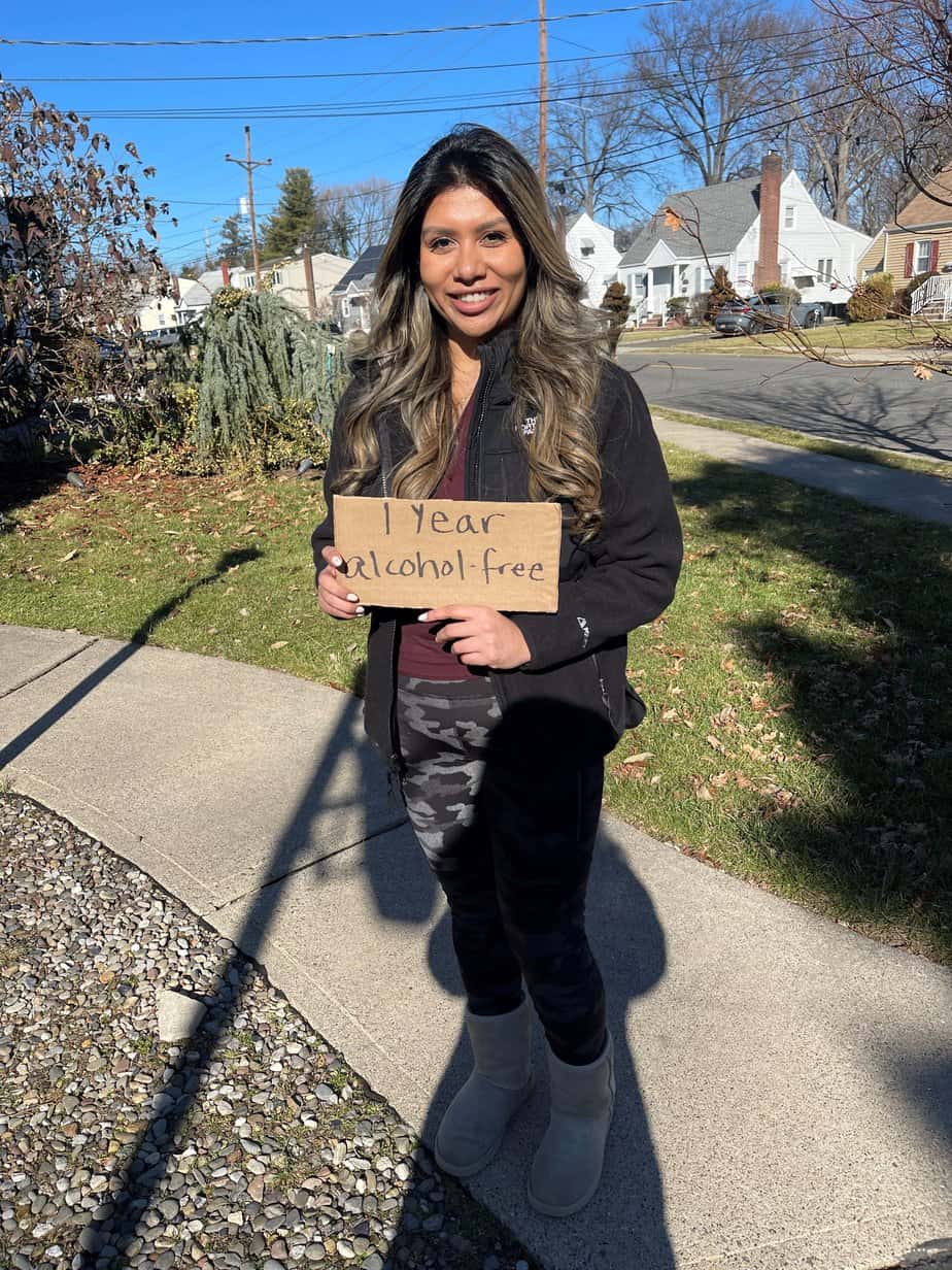 mountainside alumni holding 1 year sober sign outside