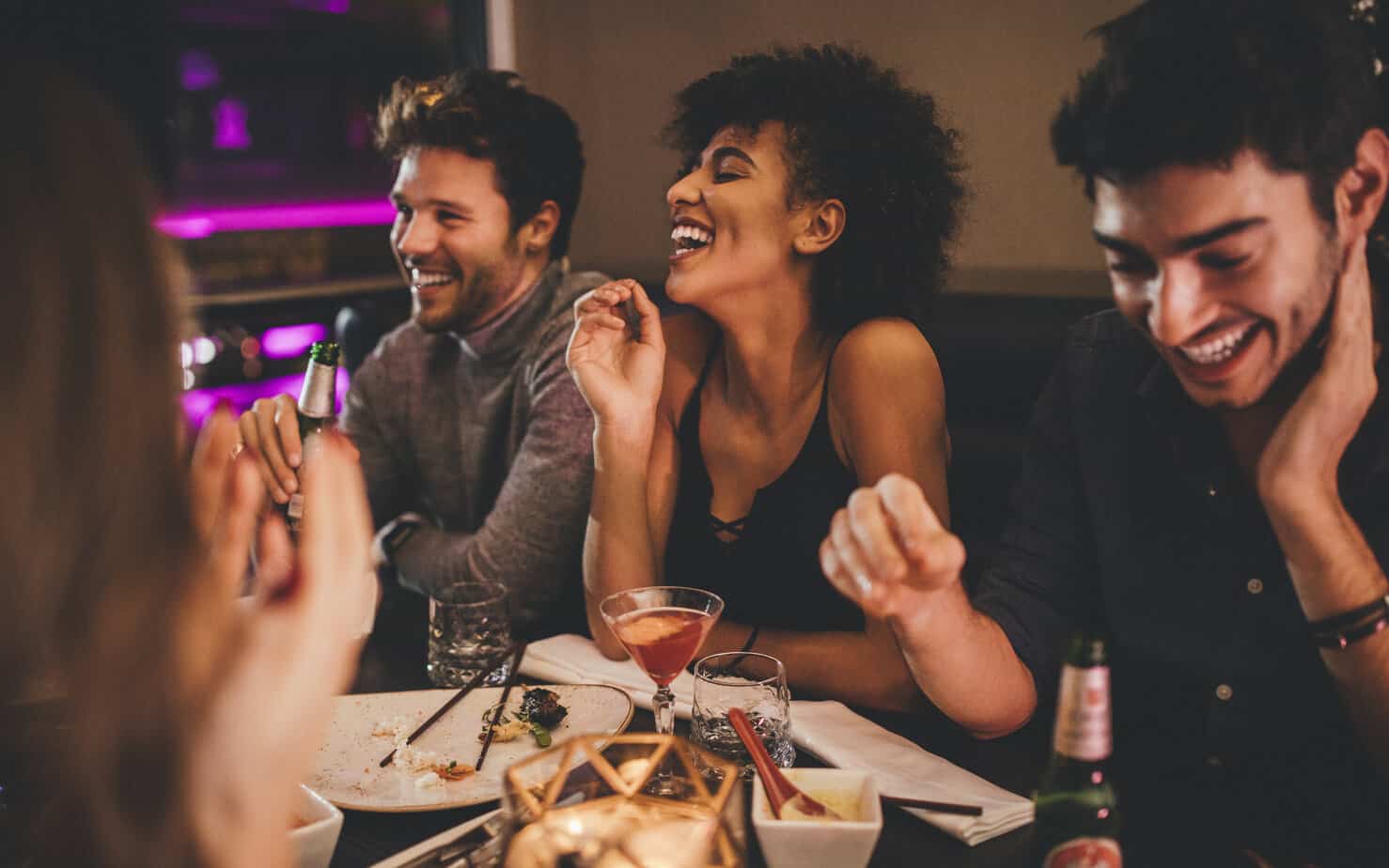 group of friends out at restaurant with food and alcohol