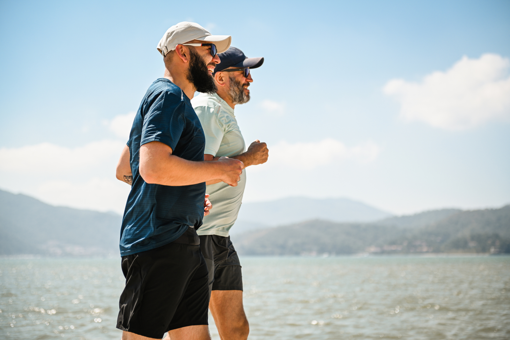 two men running side by side working on their fitness SMART goals