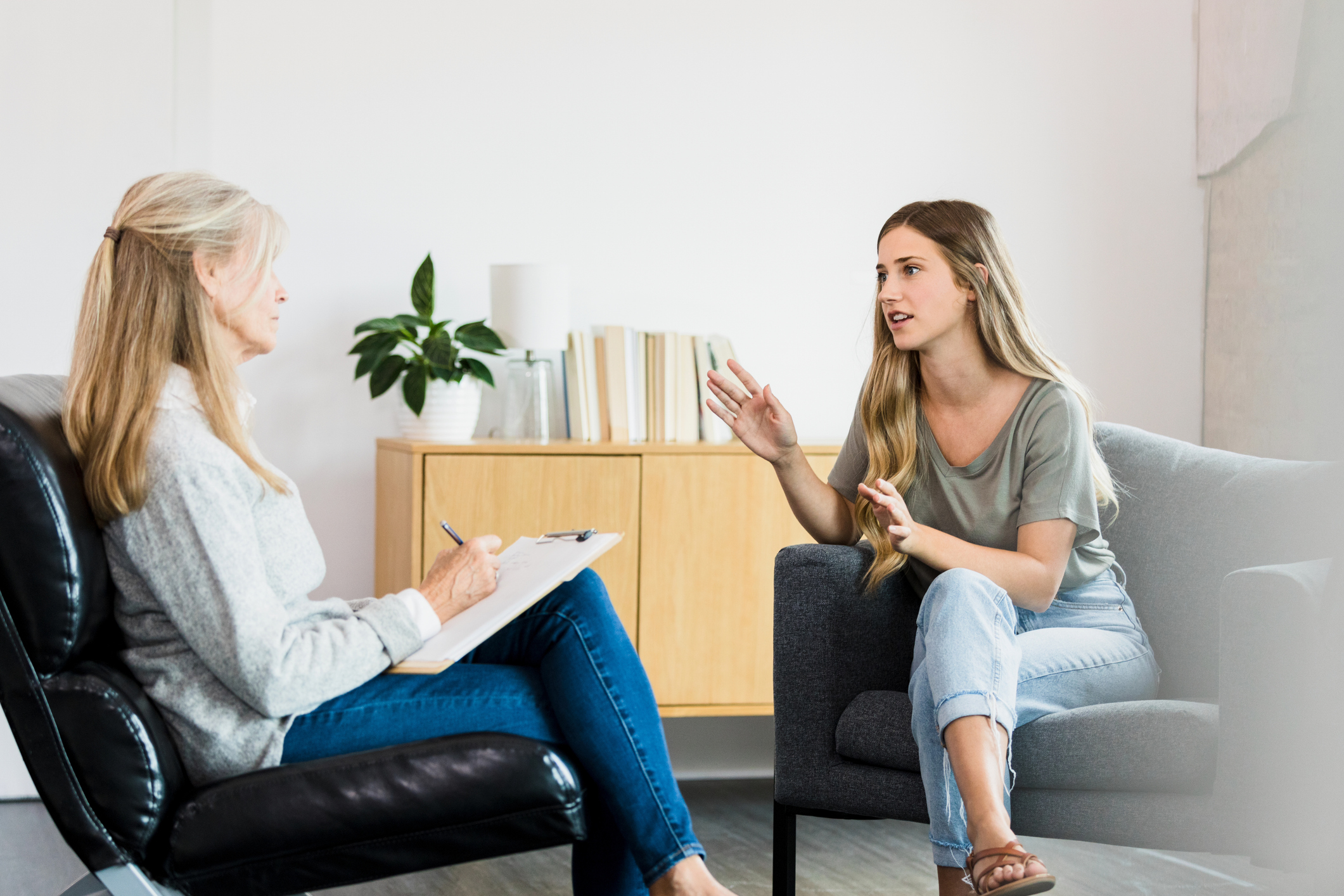 young woman talking abuot continuing care treatment plans with case manager