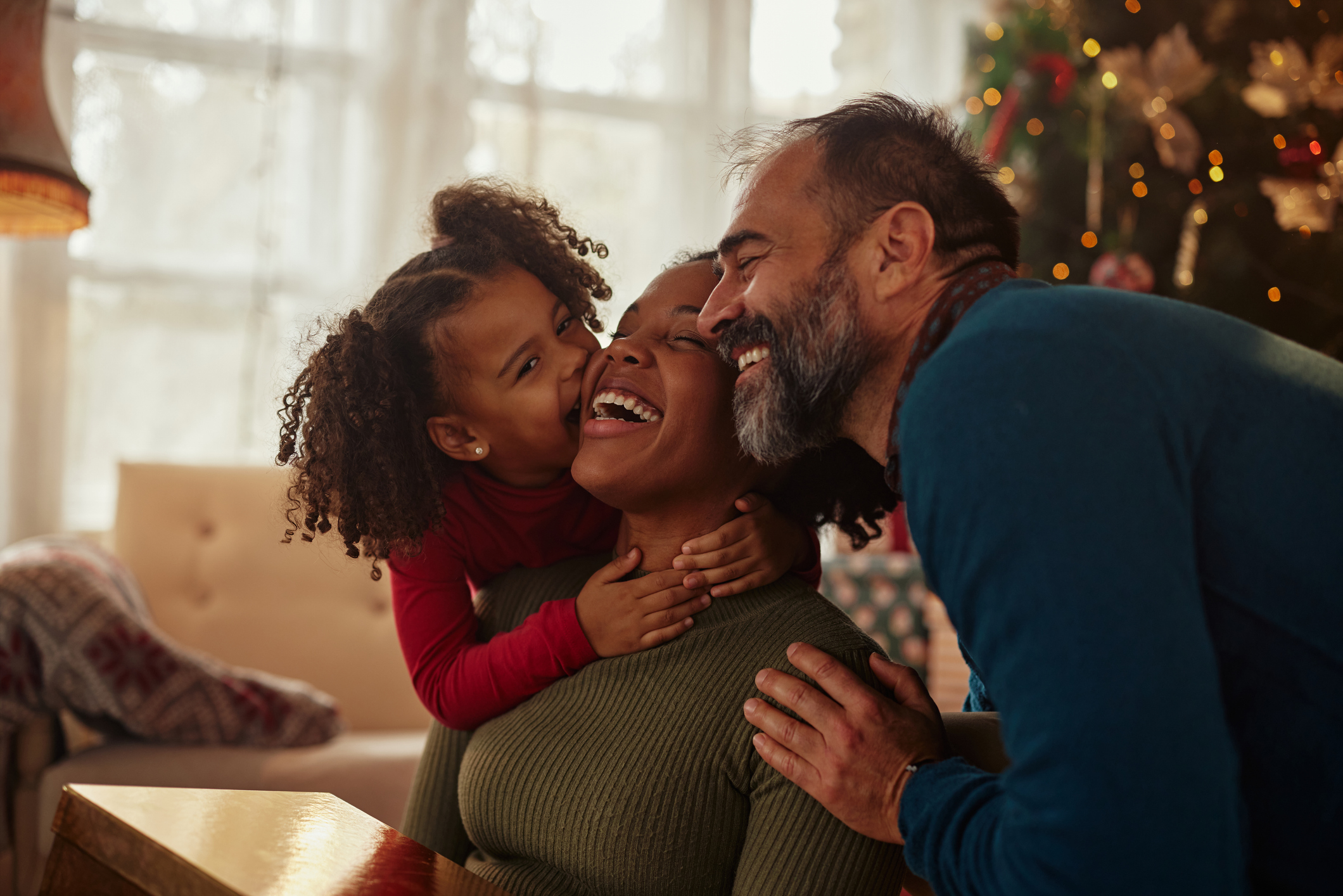 father and daughter hugging and supporting mother in recovery during the holidays