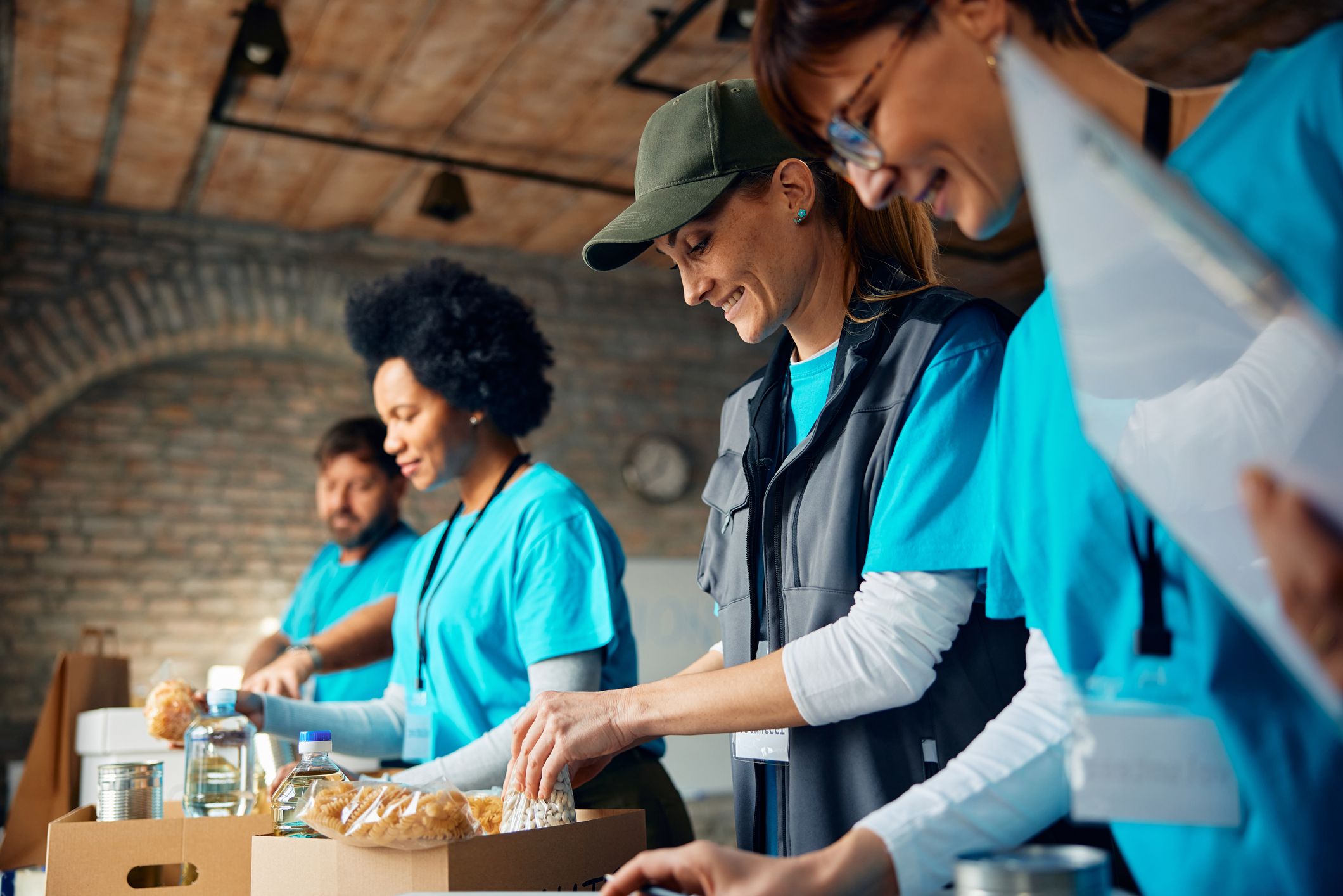 groups of people in recovery volunteering in the community by packing meals.